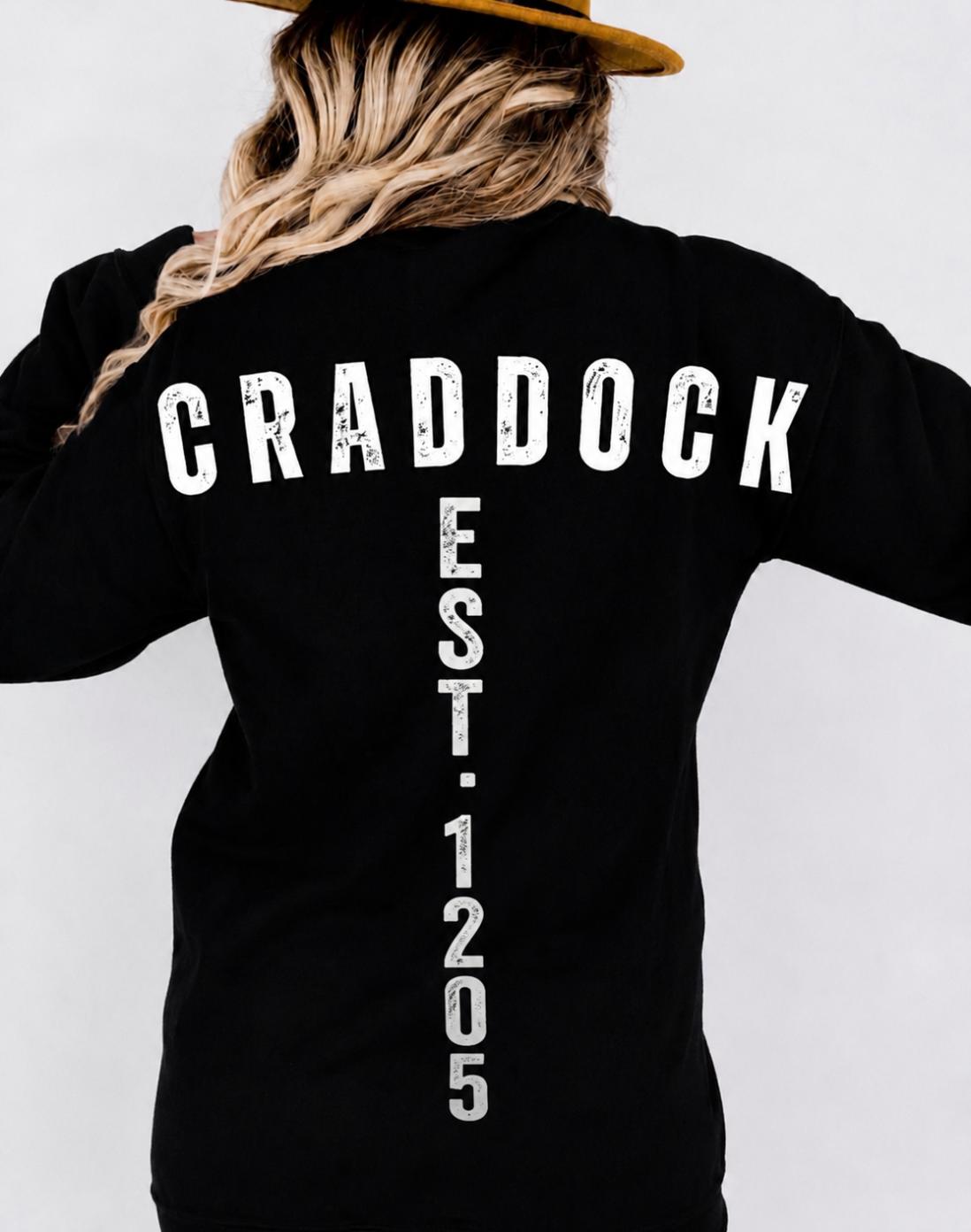 Woman wearing a black long sleeve shirt with CRADDOCK surname graphic on the back